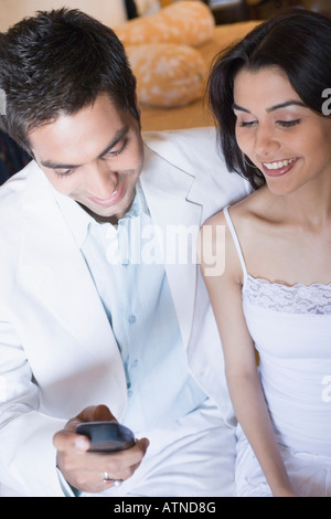 Young couple looking at a mobile phone and smiling Stock Photo