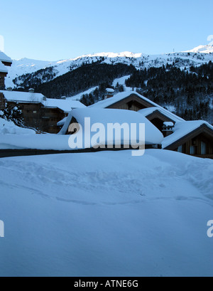 Snow covered chalet rooves in the resort of Meribel in France Stock Photo