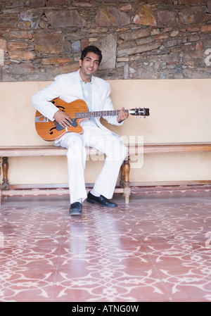 Young man playing the guitar Stock Photo