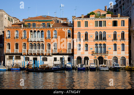 Venice, Veneto, Italy. Colourful mansions overlooking the Grand Canal, gondola passing. Stock Photo