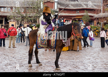 Lijiang, Girl On Horse In Sifang Square In Old City, Yunnan Province, China Stock Photo