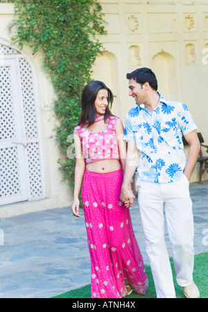 Young couple holding each other's hands and walking Stock Photo