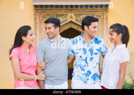 Close-up of a young couple and a mid adult couple smiling together Stock Photo