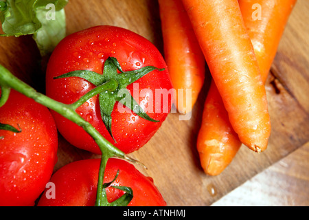 A close-up of bunch of vegetables carrots and cluster tomatoes Stock Photo