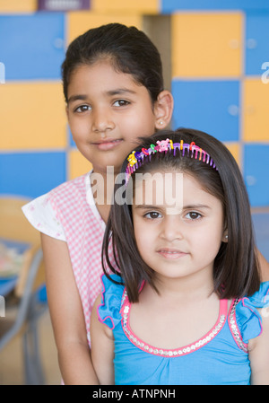 Portrait of two smiling school girls in classroom Stock Photo - Alamy