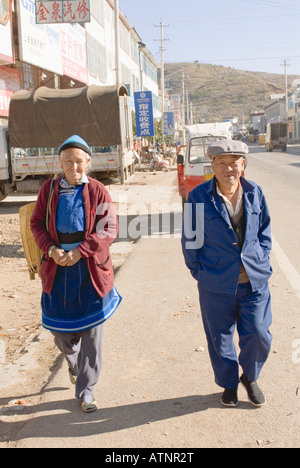 Elderly Chinese Man And Woman Smiling Walking Down The Street, China, Shuanglang, Erhai Lake, near Dali, Yunnan Province Stock Photo