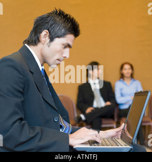 Side profile of a businessman using a laptop Stock Photo