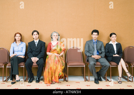 Portrait of five business executives sitting on chairs Stock Photo