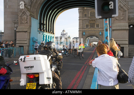 Cyclists converge after Tower Bridge closes London UK Stock Photo