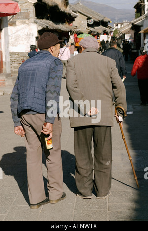 China, Chinese Old Men Walking On A Dali Ancient City Street, Yunnan Province Stock Photo