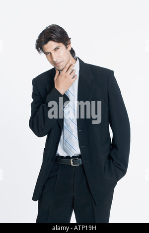 Portrait of a young man standing with his hand in his pocket Stock Photo
