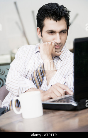 Businessman using a laptop in a restaurant Stock Photo