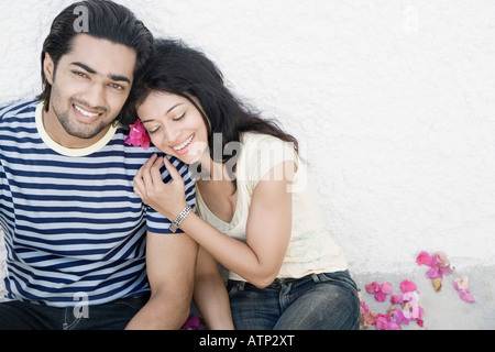 Young woman leaning on a young man and smiling Stock Photo