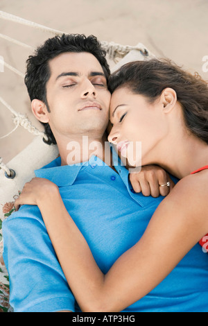 High angle view of a young couple sleeping in a hammock Stock Photo