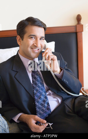 Portrait of a businessman talking on the telephone and smiling Stock Photo