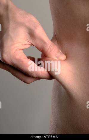 Man pinching waist Stock Photo