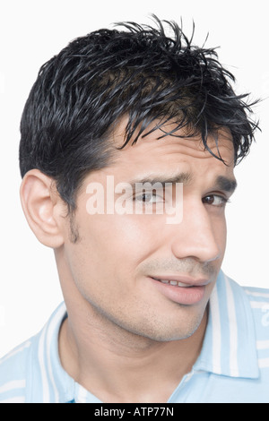Portrait of a young man smirking Stock Photo