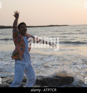 Young man dancing on the coast Stock Photo