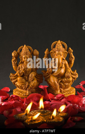 Close-up of an oil lamp burning in front of religious idols Stock Photo