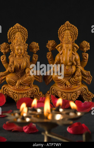 Close-up of an oil lamp burning in front of religious idols Stock Photo