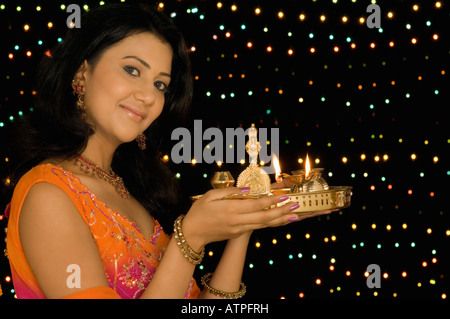 Portrait of a young woman holding a diwali thali Stock Photo