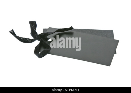 Black tags fastened with ribbon on white background Stock Photo