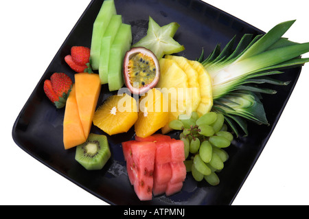 Sliced fresh tropical fruit on plate Stock Photo