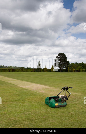 Lawnmower sits on a freshly mown cricket pitch Stock Photo
