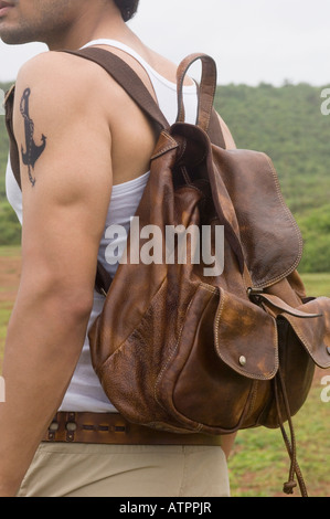 Side profile of a young man carrying a backpack Stock Photo