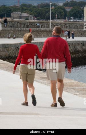 woman and man strolling on the pier