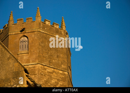 Church Tower with moon in background Stock Photo