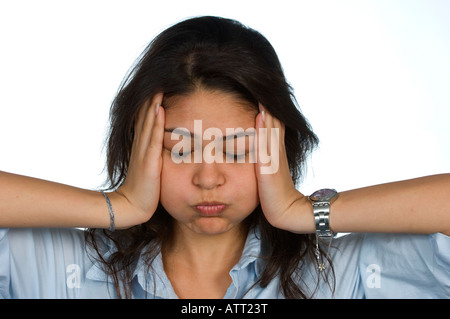 young woman clutching head with her hands Stock Photo