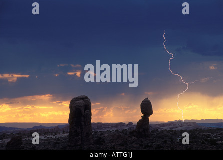 Lightning Strike at Sunset Behind Balanced Rock in Arches National Park Grand County Utah Stock Photo