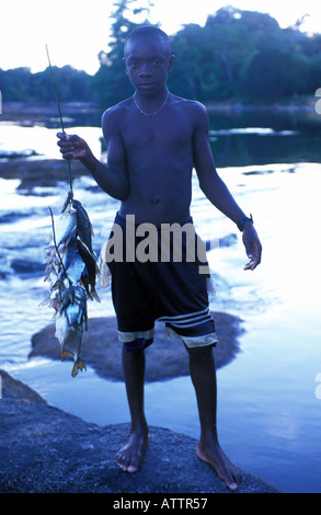 Saramaccan boy fishing in the Pikin Rio river Stock Photo