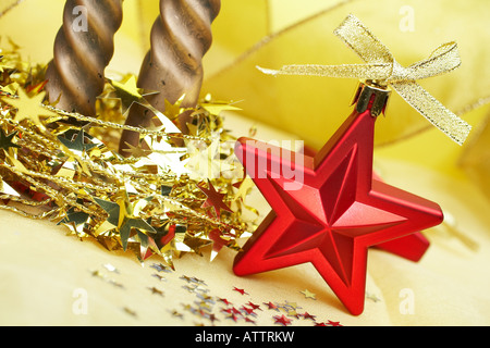 Christmas decoration with red stars and candles over yellow background Shallow DOF Stock Photo