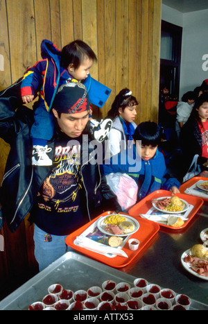 Native American family getting Christmas dinner at soup kitchen. St Paul Minnesota USA Stock Photo