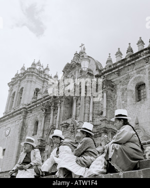 Peruvian Aymara Quechua peasant women at the cathedral in Plaza de Armas in Cusco Cuzco in Peruvian Andes in Peru Latin South America. People Travel Stock Photo