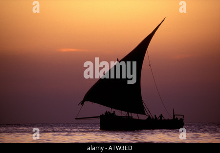 Ocean going Arabian style sailing dhow at sunset off the coast Zanzibar Tanzania East Africa Stock Photo