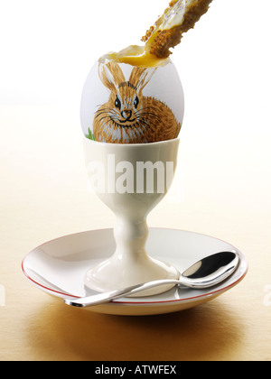 Painted Easter Egg with a rabbit decoration, sharp Focus. Boiled egg with soldier Stock Photo