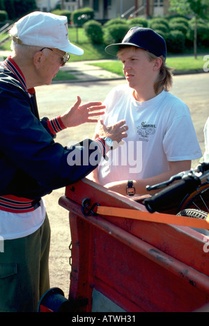 Senior Boy Scout leader organizing camping trip ages 80 and 17. St Paul Minnesota USA Stock Photo