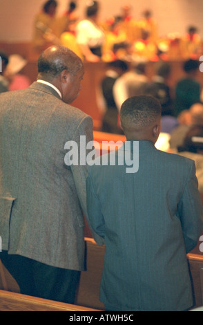 Black father and son ages 55 and 14 standing during church service. Mount Olivet Baptist Church St Paul Minnesota USA Stock Photo