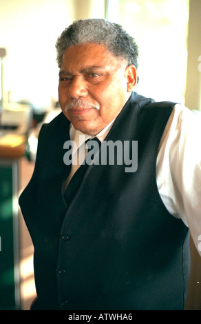 Thoughtful African American bartender age 60 at wedding reception. San Francisco California USA Stock Photo