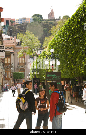 MEXICO Guanajuato Three Mexican teenagers talking together in el Jardin de la Union el Pipila monument backpacks and Tshirts Stock Photo