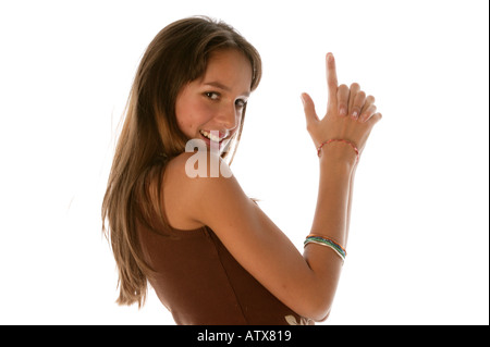 Young woman looking at camera gesture from 007 movie Stock Photo