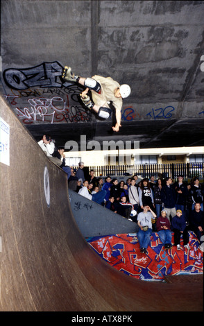 Youth doing tricks at indoor skate park in West london Stock Photo