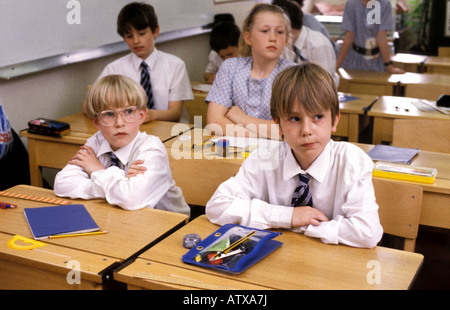 Children sitting at desks listening to the teacher in a south London preparatory school Stock Photo