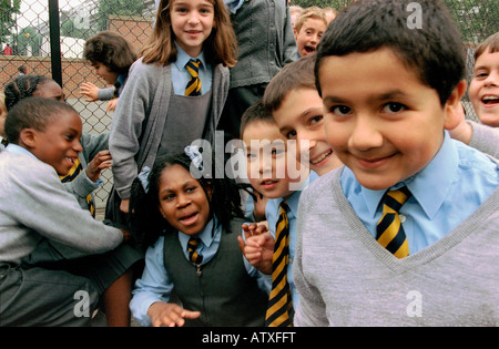 Group of primary school children playing in school yard. Stock Photo