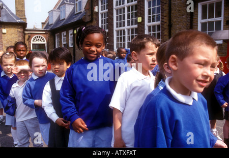 primary school children lining up in playground after break time Stock Photo