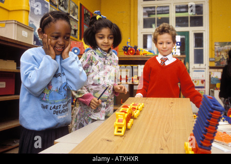 Small group of primary age children experimenting with motion in science class Stock Photo