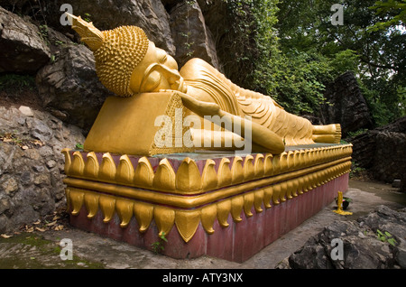 Reclining golden Buddha statue of Wat Prabang Phoutthalawanh on Mount Phu Si, Luang Prabang. Laos. Stock Photo